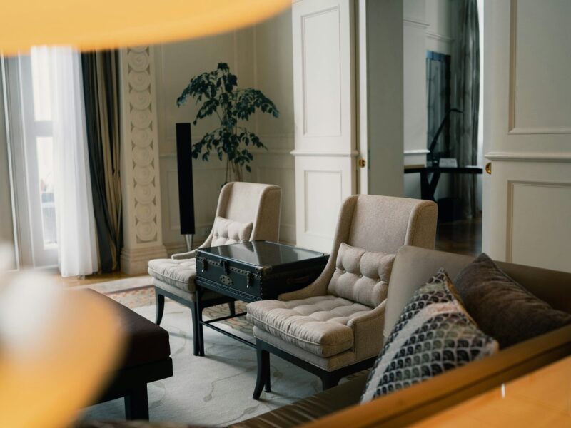 black and white sofa chair near white window curtain