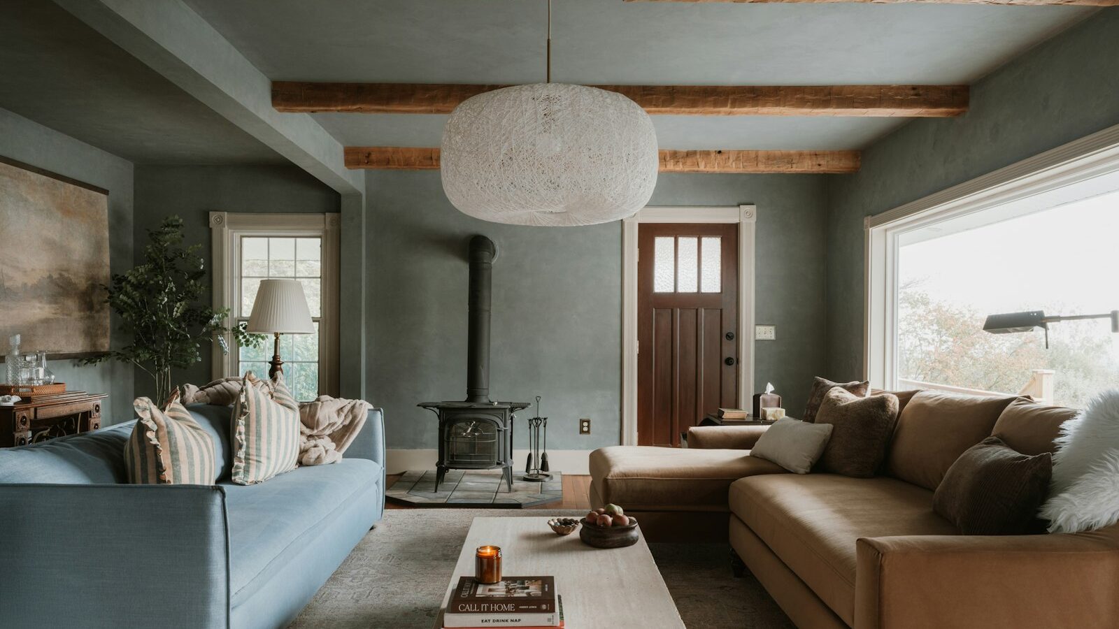 Cozy living room with sectional sofa and wood stove.