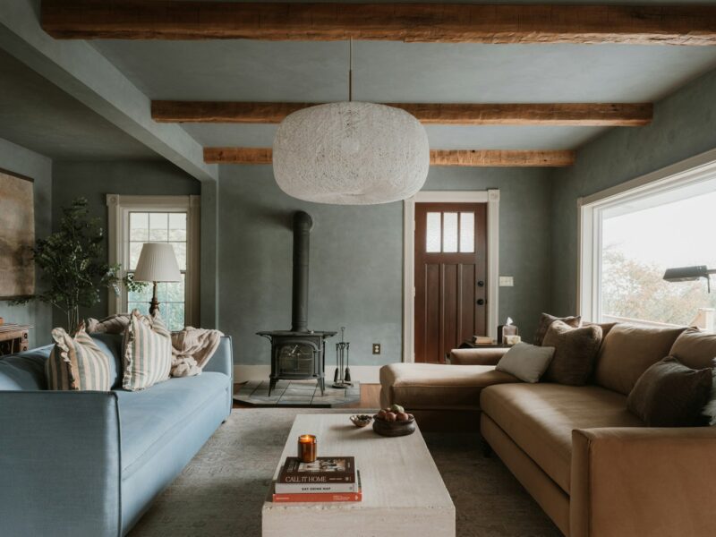 Cozy living room with sectional sofa and wood stove.