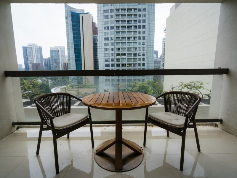Two chairs and a table on a balcony