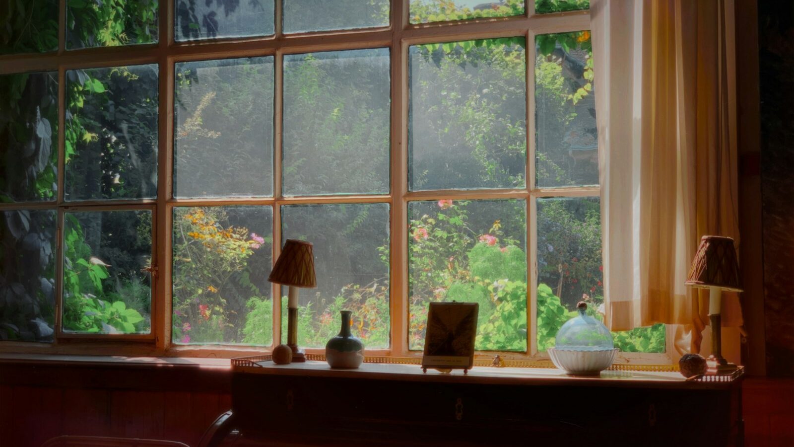 brown wooden desk with table lamps beside window