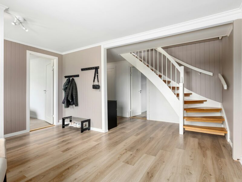A living room filled with furniture and a staircase