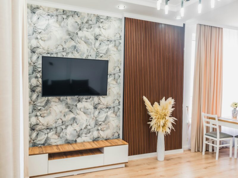 Modern living room with tv, console, and pampas grass decor.