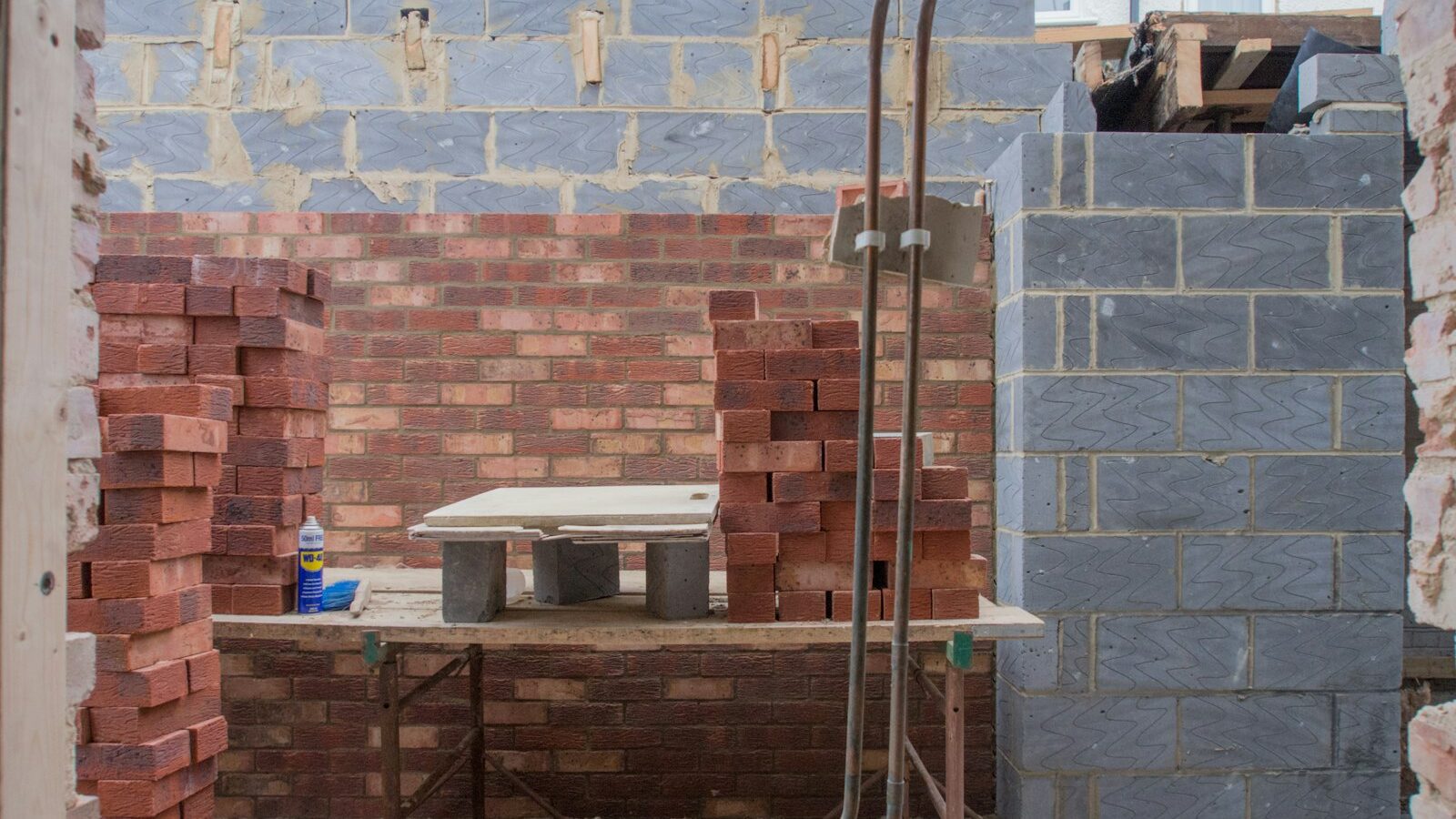 brown wooden table beside brown brick wall