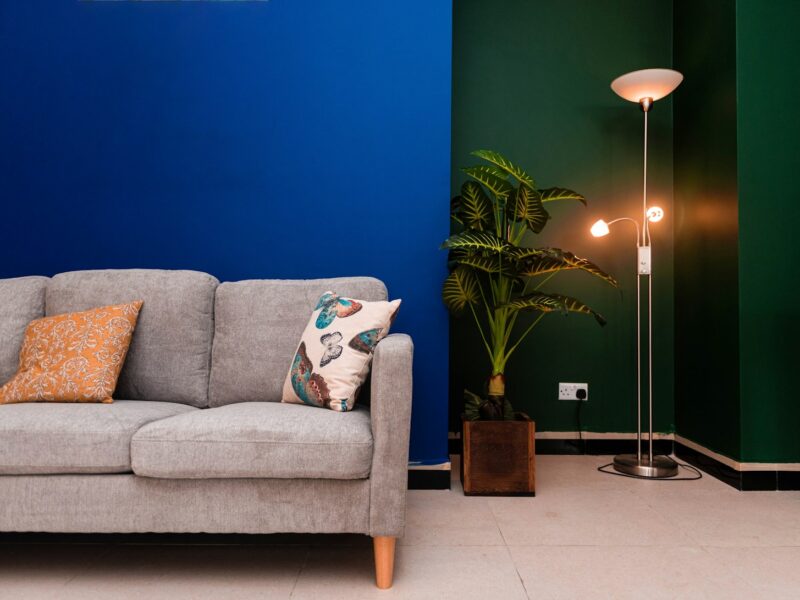 a living room with a couch and a lamp