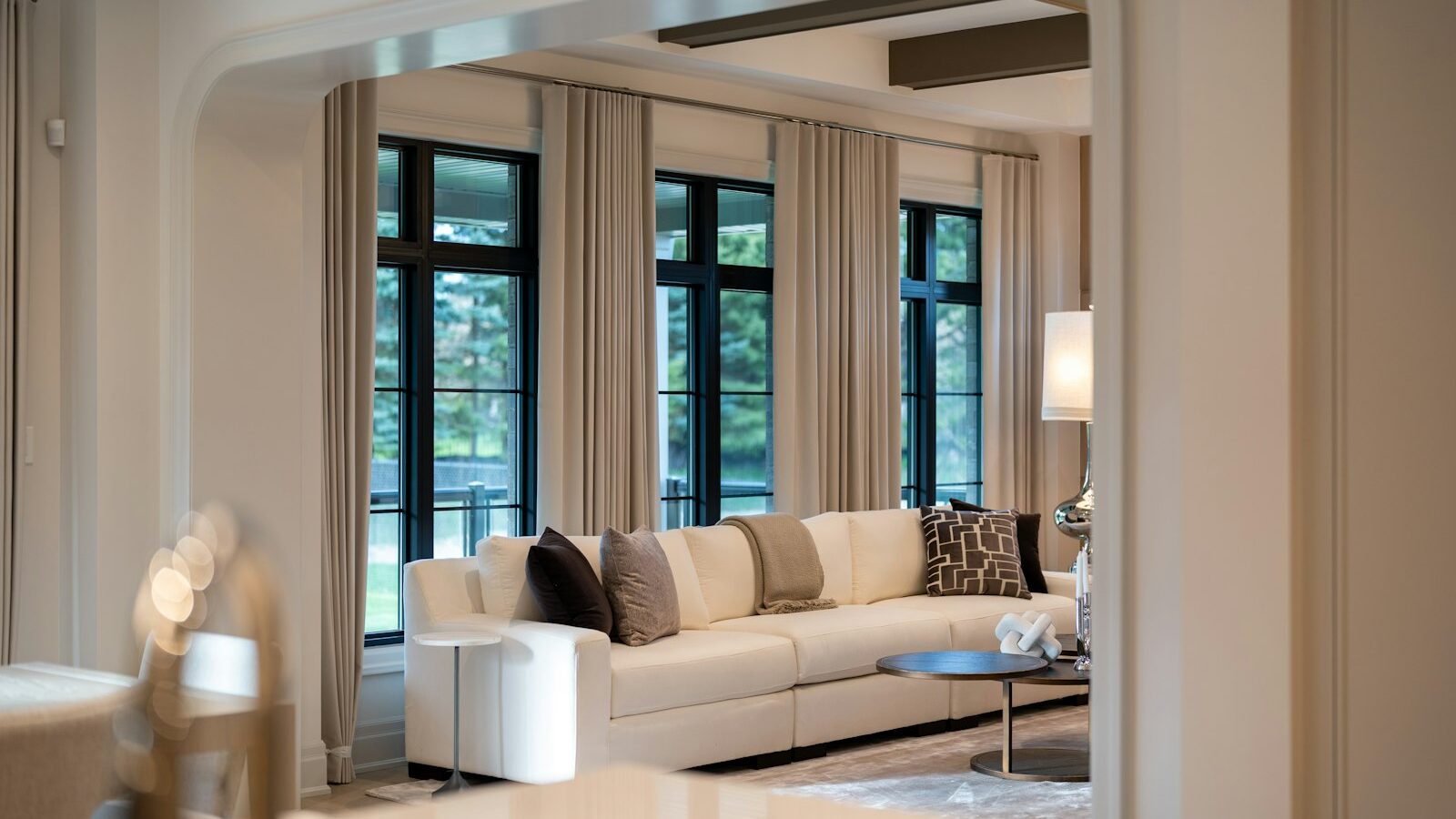 Elegant living room with large sofa and windows