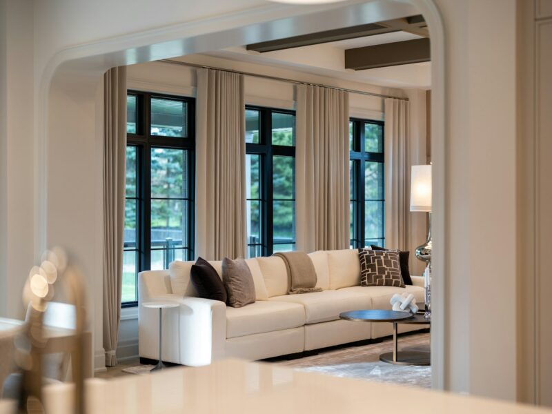 Elegant living room with large sofa and windows