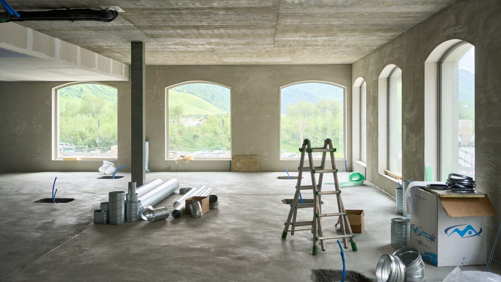 A large room with windows and a ladder
