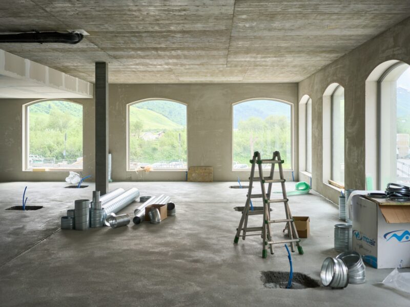 A large room with windows and a ladder