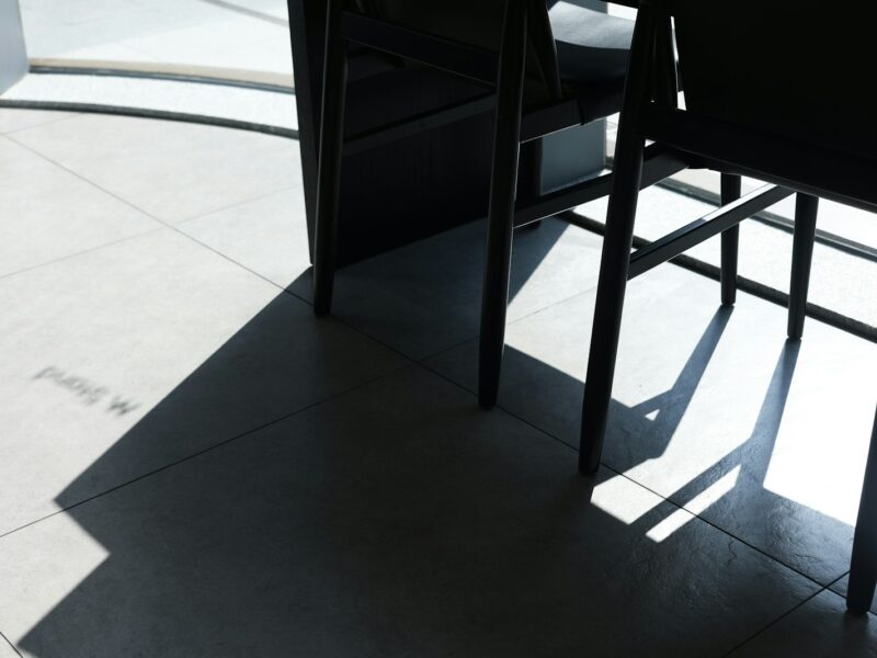 a couple of chairs sitting on top of a tiled floor
